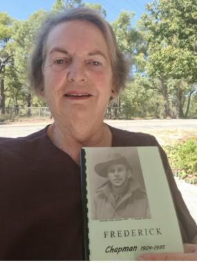 Janice-Chapman-holding-a-memoir-of-her-father-Frederick-Chapmans-army-service.--Australia,-May-2021