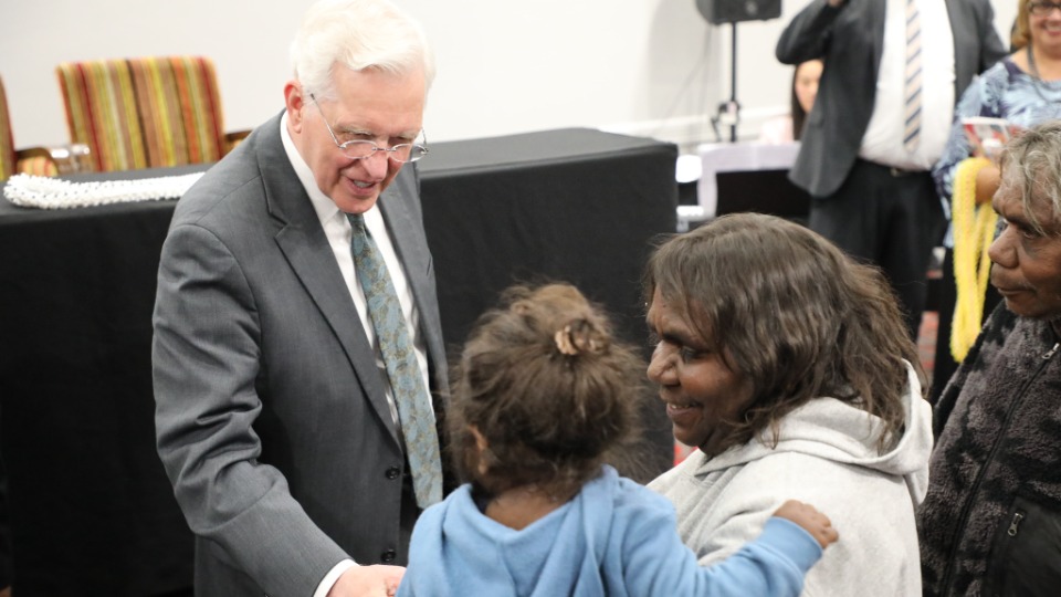 Elder-Christofferson-greets-a-mother-and-child-in-Alice-Springs,-Australia-on-25-May-2023.