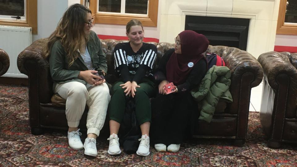 Latter-day-Saint,-Paige-Rogers-(left)-talks-with-Charlotte-Pratt-(centre)---Baha'i-faith-and-Izzati-Effindi-(right)---Muslim-faith-at-the-annual-Interfaith-Information-Evening-held-at-St-Margaret's-College-in-May-2021.-Photographer-Suzanne-Gillies