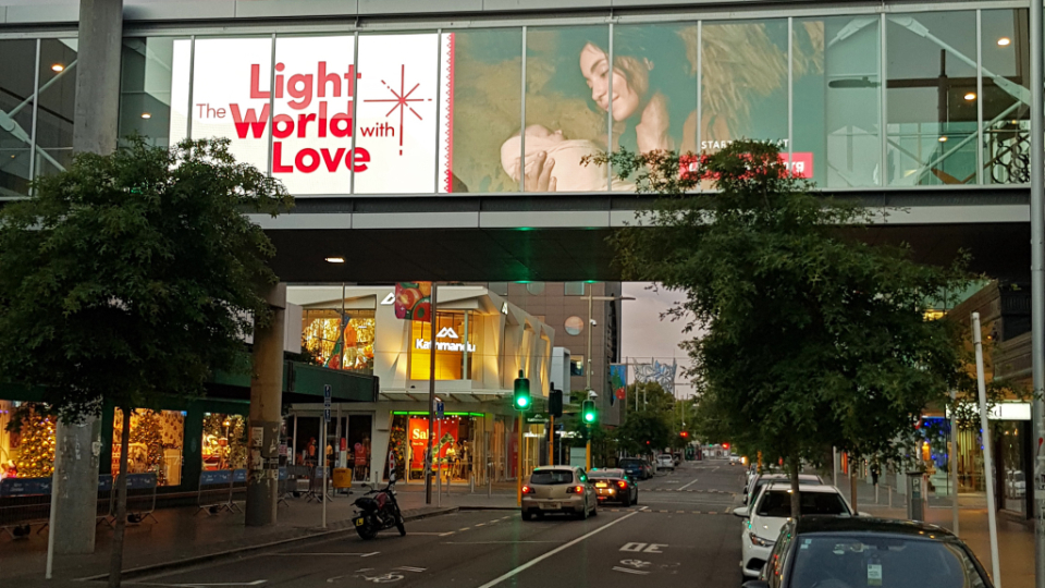 Digital-sign-with-'Light-the-World-with-Love'-message-in-central-Christchurch,-New-Zealand.-December-2021