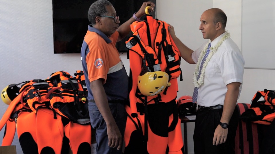 Manea Tuahu (pictured on the right) and Sam Roscol, project chair, inspect rescue equipment donated by The Church of Jesus Christ of Latter-day Saints.    