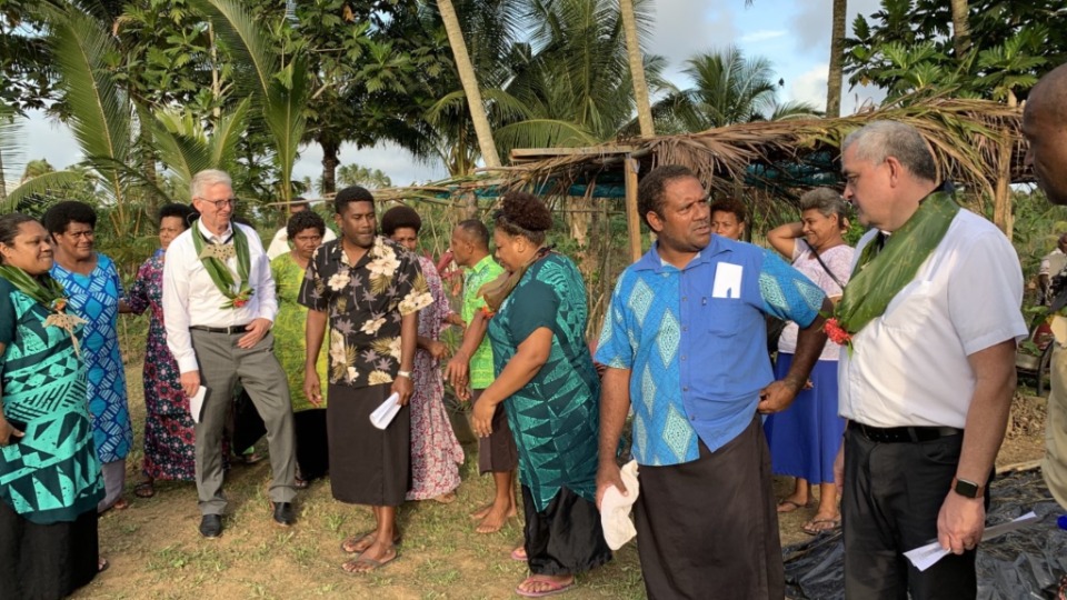 Paul Reid, Pacific Area Welfare and Self Reliance manager, and Dean Westerlund, Education manager, meet with local leaders and  villagers in Fiji. June 2022