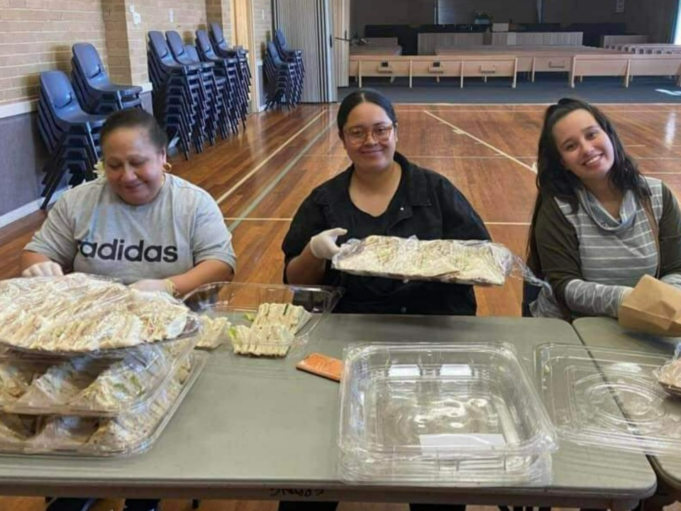 Volunteers in Melbourne pack food packs for vulnerable members of their community. March 2022.