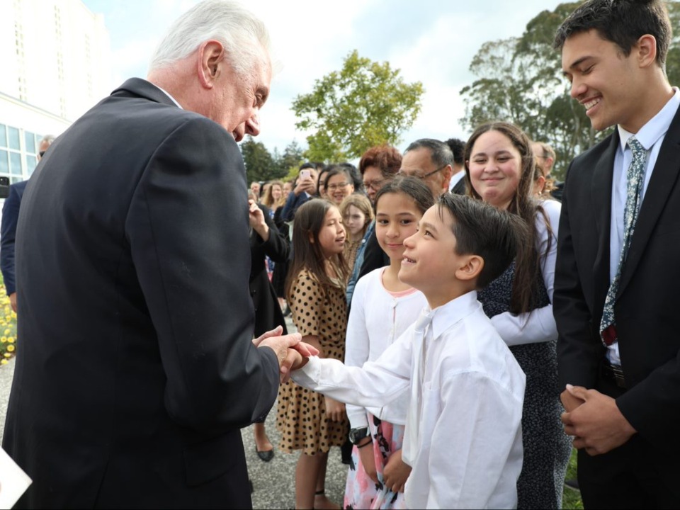 Elder Uchtdorf greets members of the Church outside the Hamilton New Zealand Temple.